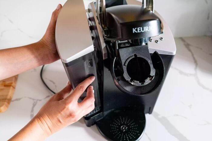 Person assembling a Keurig coffee maker
